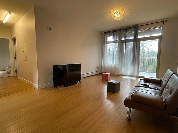 Living room with sliding doors to balcony and view