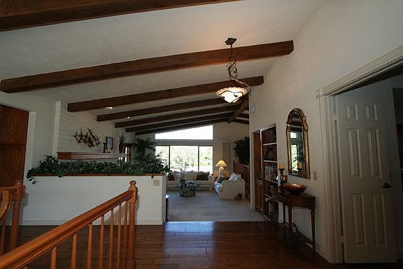 Warm and inviting with solid wood flooring, wood beams and fireplace