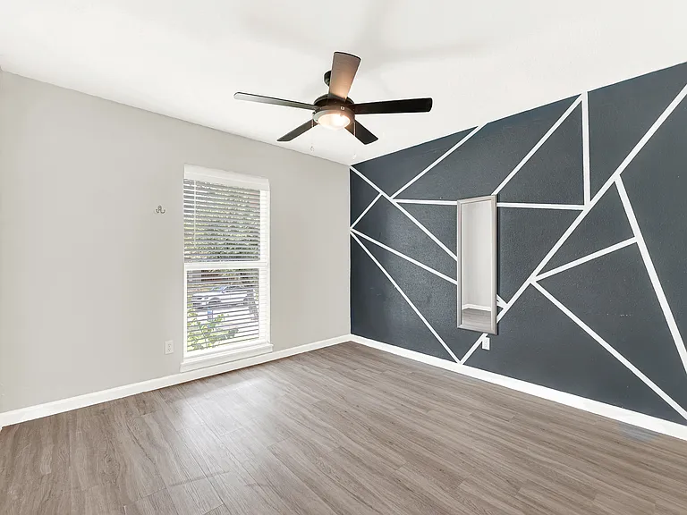 Secondary bedroom with accent wall.
