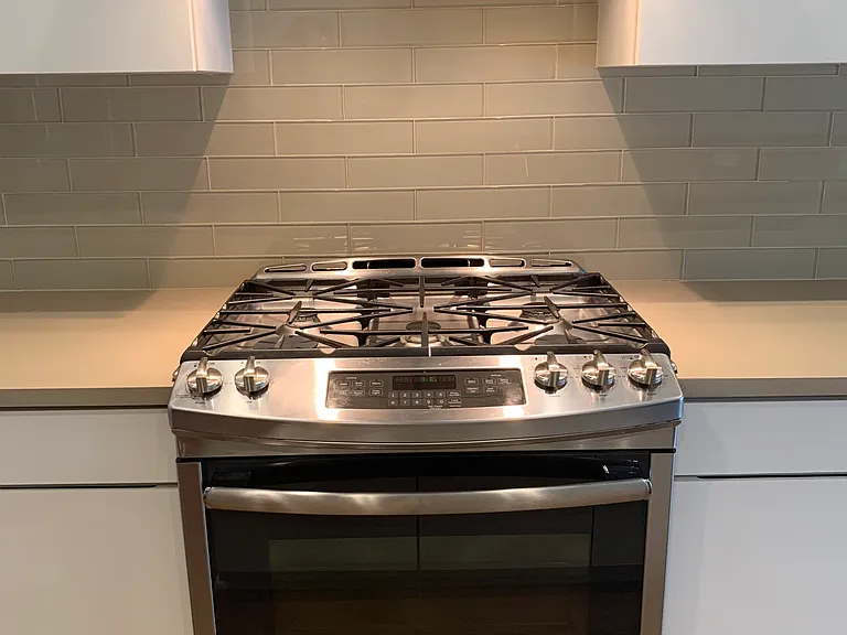 Stainless steel gas range w/ oven and vent hood