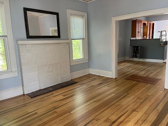 View from living room to dining room and kitchen. Notice the open doors on the cabinet in the dining room on the left for extra storage on the back side of the half wall.