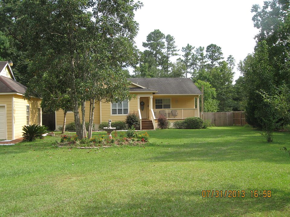 Front of house with garden and magnolia trees