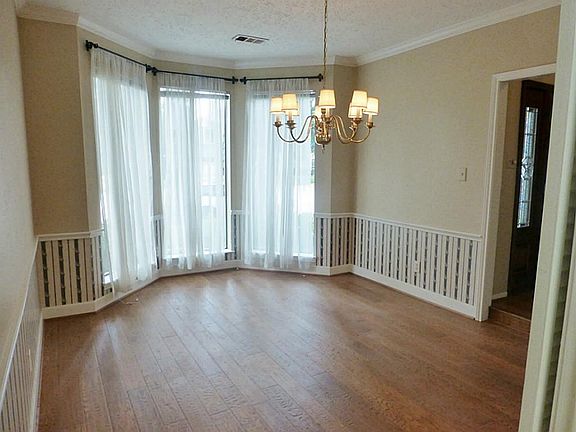 Formal dining room with bay window.