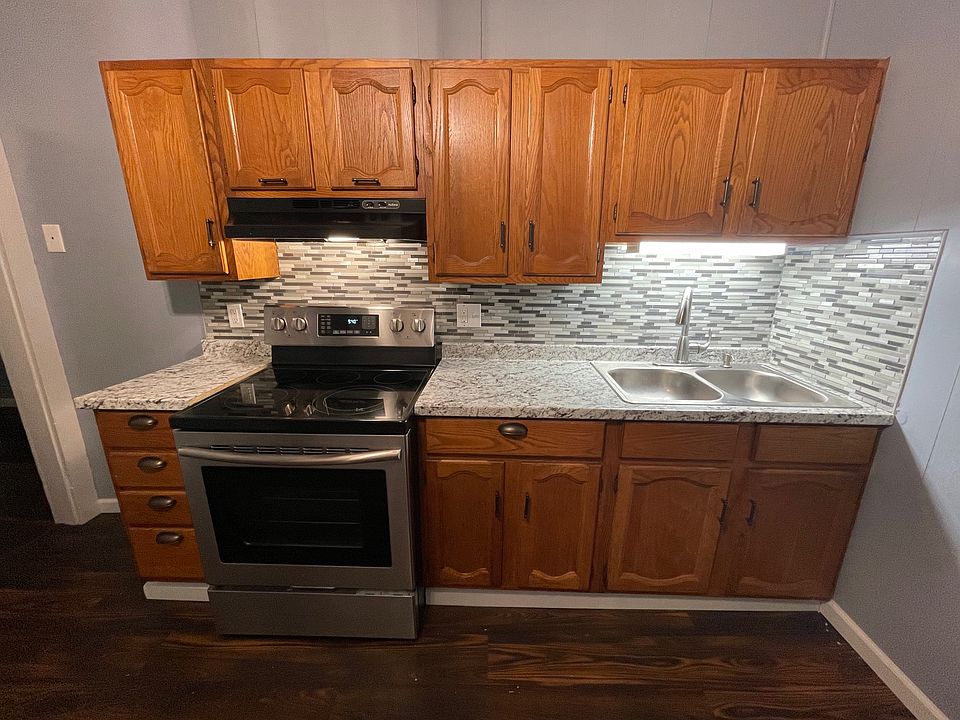 Lots to love in the kitchen with an updated countertop and tiled backsplash. Enjoy making meals on a stainless steel smoothtop range
