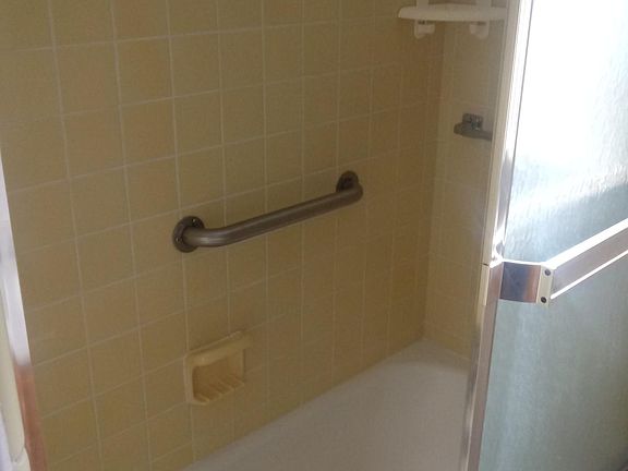 Bathroom has a heat lamp. Clean
