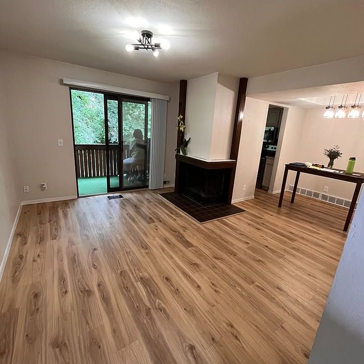 Living room with a natural wood burning fireplace.