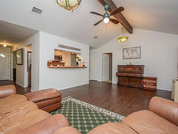 This living room is fantastic! The options are endless and it seems as though the size of this space is endless as well! Check out those high ceilings, beautiful laminate floors, and the gorgeous accent beam.