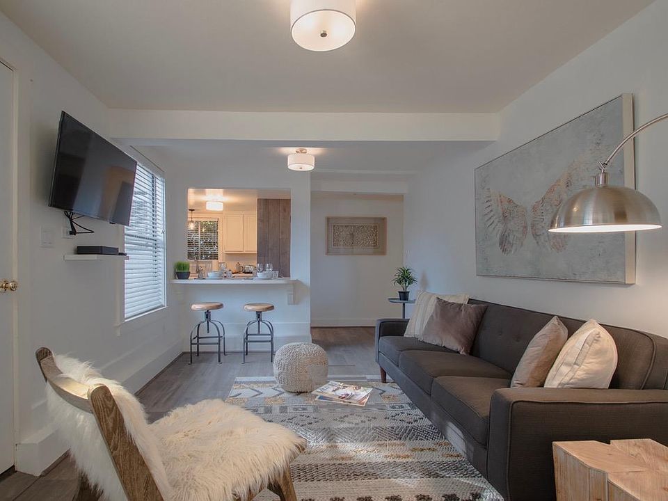 Comfy, warm and stylish living room looking onto the kitchen