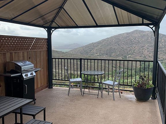 Outdoor living room, couch, BBQ and table included