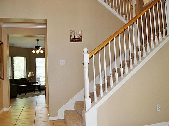 VIEW OF SPLIT STAIRCASE AT ENTRY