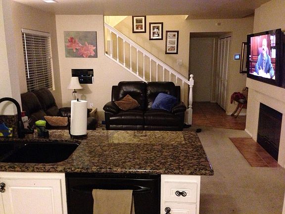 From Kitchen back to TV room, Stairs. At back is laundry and bathroom with door out to garage.