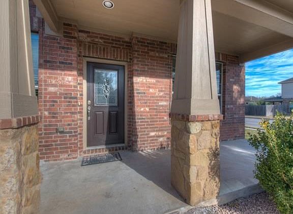 Covered front porch provides a buffer from inclement weather while still allowing lots of natural light into the home. Imagine sitting here in the afternoons visiting with neighbors while watching the kids play.