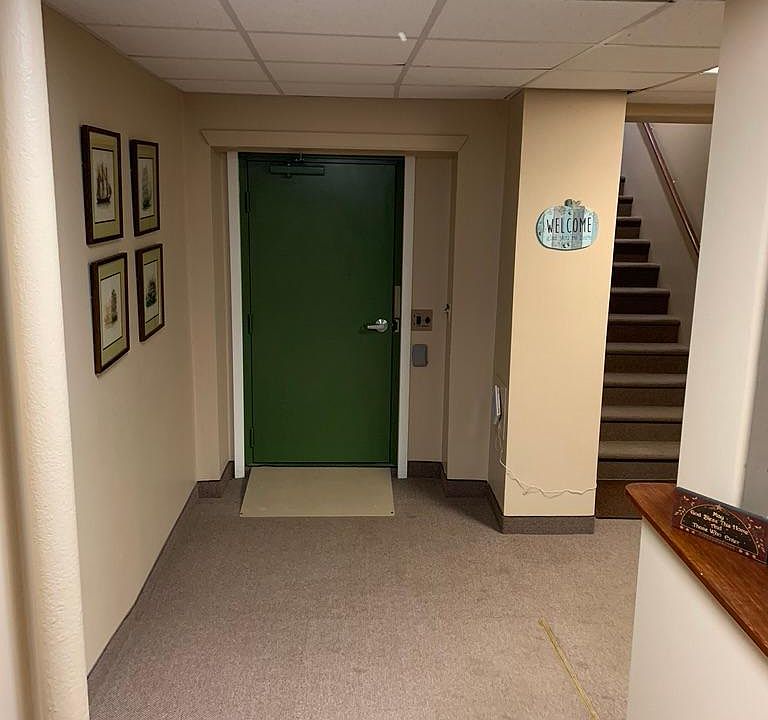 Entry to the building shows elevator door and steps