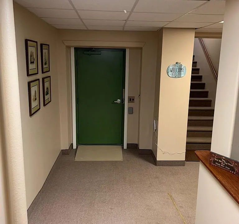 Entry to the building shows elevator door and steps