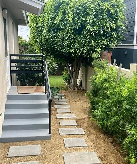 Side yard with steps from kitchen.