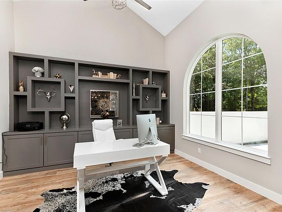 Private study with wall of custom built-ins overlooking the front courtyard