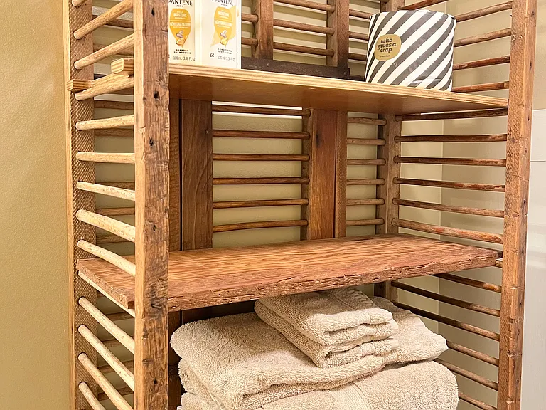 Antique shelving with starter bathroom supplies.