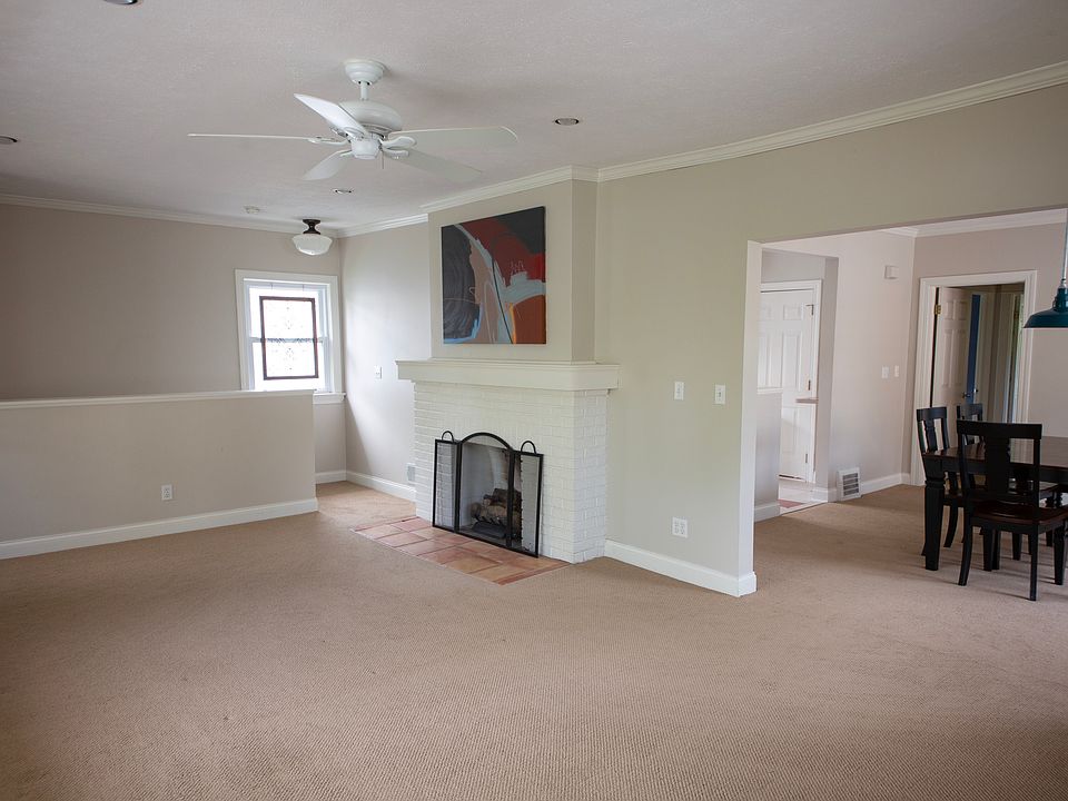 Comfortable living space featuring a decorative fireplace and seamless flow into the dining area for everyday living