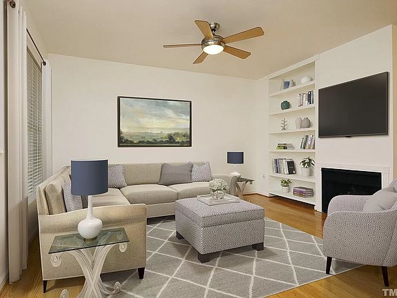 Living room with gas fireplace and built-in shelves. Main floor.