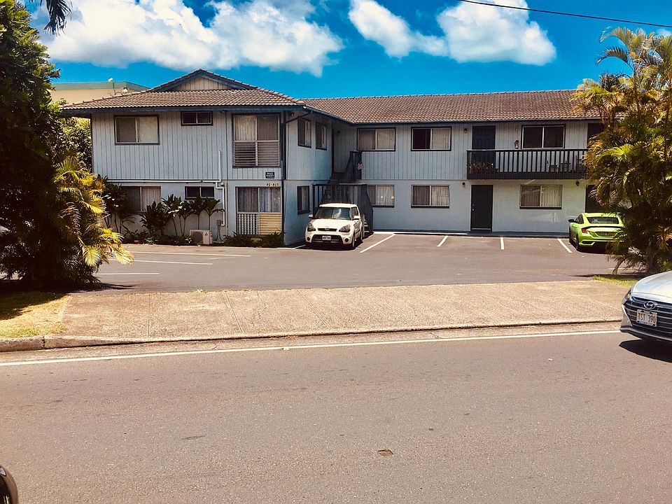 Apartment #3 is between the two cars in the lot.