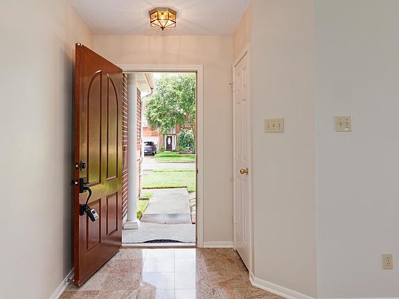Welcoming entry way with granite tile.