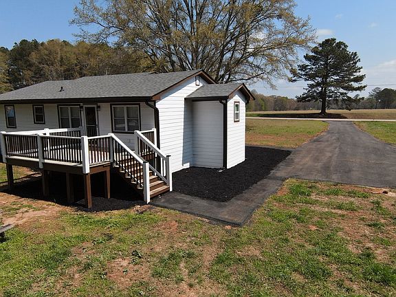 Rear view of deck entrance and parking area.