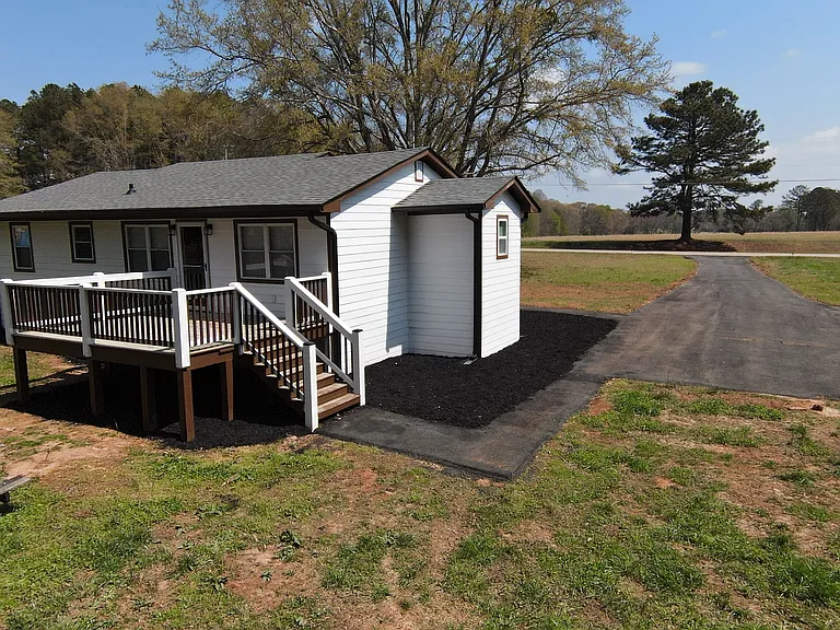 Rear view of deck entrance and parking area.