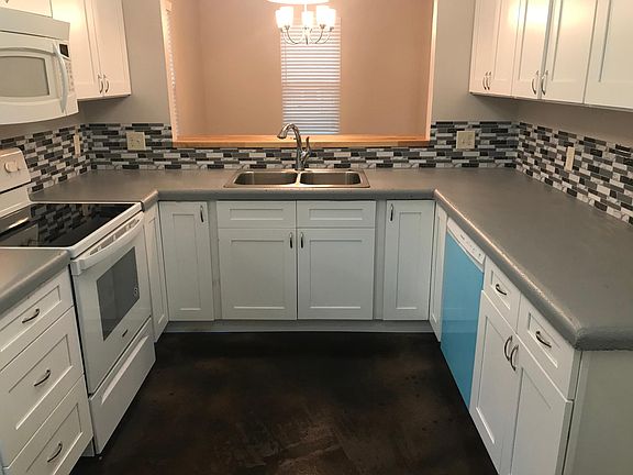 The blue plastic comes off the dishwasher! Concrete counters and two corner lazy Susan's to maximize useable storage.