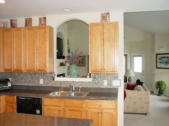 Spacious kitchen with slate backsplash and island/bar is a cooks delight.