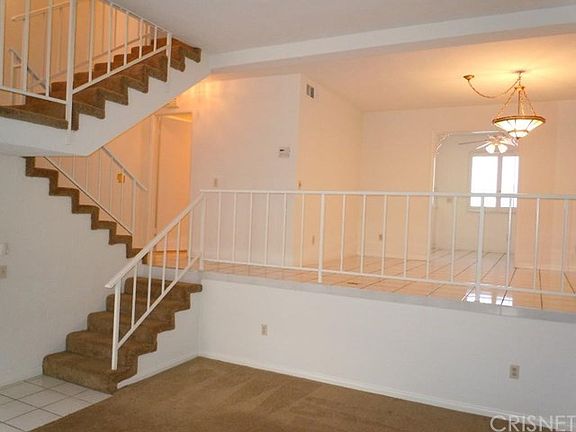 Living Room - view to dining area, powder room is on the left