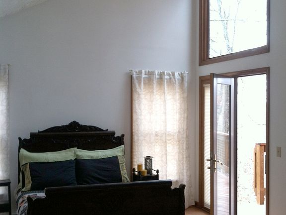 Bedroom in master suite with view of stars & access to deck