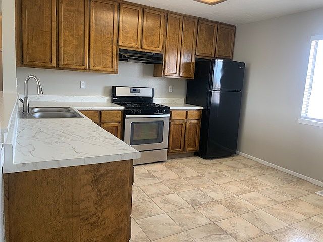Beautiful, spacious dine-in kitchen with ample storage, great natural light, modern appliances including a gas stove, and new countertops and faucet with built in sprayer.