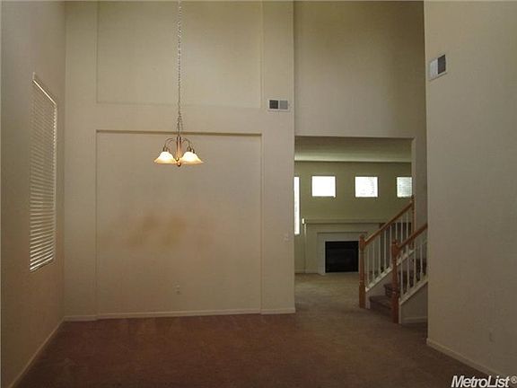 A cathedral ceiling is in the entry and dining-living space.