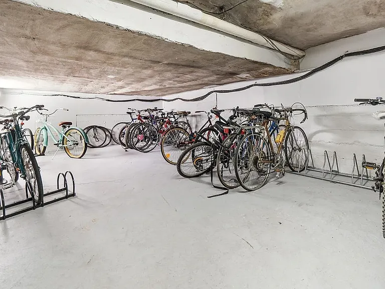 Locked bicycle storage room on street level of building.