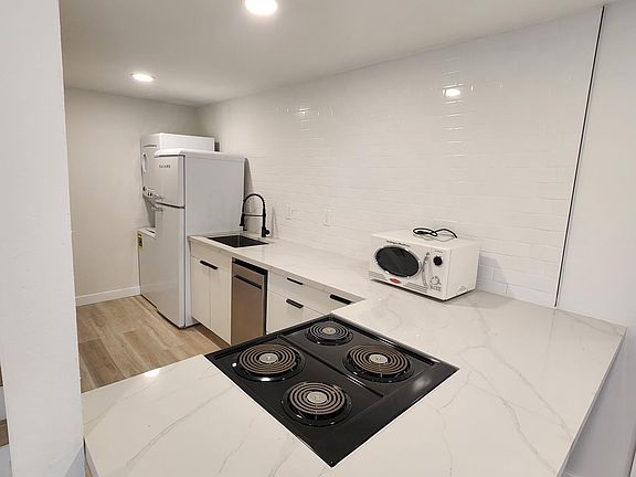 Brand new appliances, bar seating, tiled ceiling to counter backsplash