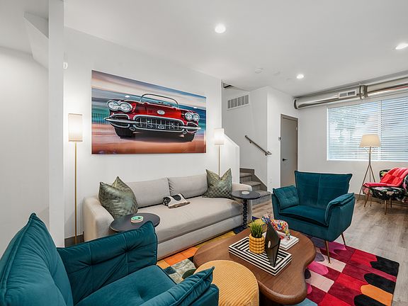 Living room thoughtfully designed with a queen pull-out and gallery-worthy photography by Ryan Smith Fine Art.