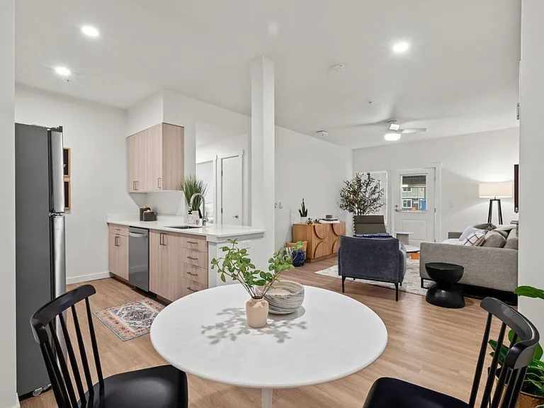 Indulge in the elegance of wood plank-style flooring, offering spacious rooms that effortlessly accommodate all your needs, including a dedicated dining area.