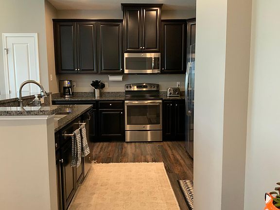 Amazing kitchen featuring stainless steel appliances, granite countertops, double bowl sink, maple cabinetry and pantry.