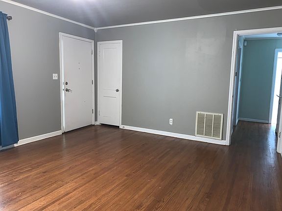 Living room entry with coat closet, view down hall
