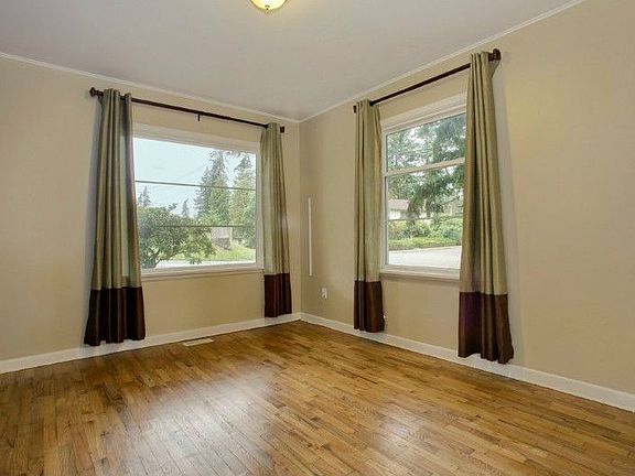 Bedroom with wood floors and large windows!