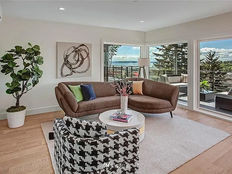 Bright, sun-drenched top room opening to an expansive entertainment deck.