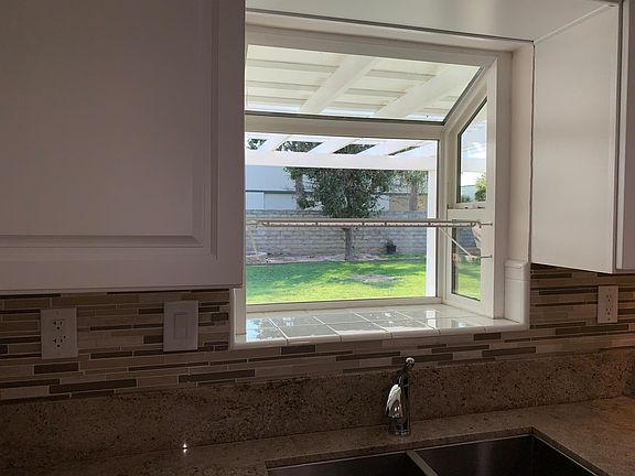 Great view of rear yard from kitchen sink garden window.