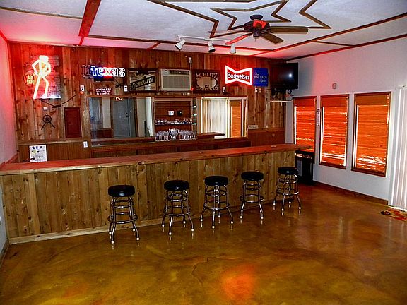 Gameroom with Entertainment Bar & 1/2 Bath for easy access. Doors Leading to the Pool Area