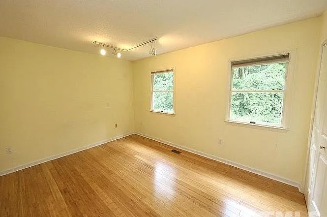 Two large bedrooms are upstairs. This one has two closets and overlooks the backyard.