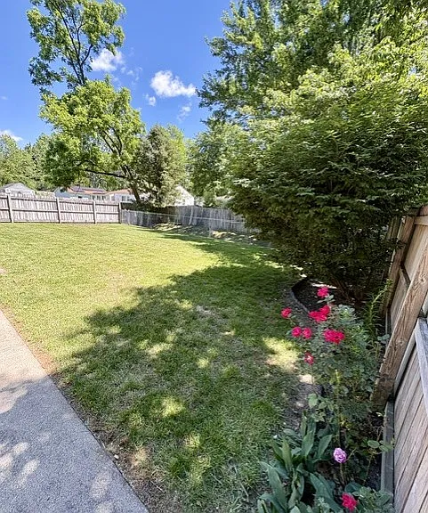 Privacy fenced backyard with established landscaping