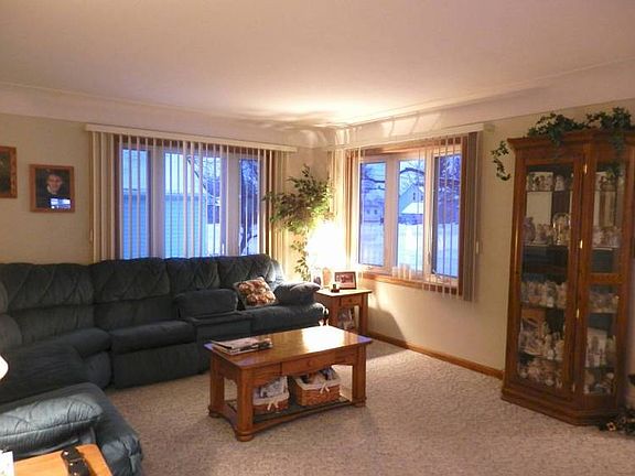 Living room offers hardwood floor under carpet