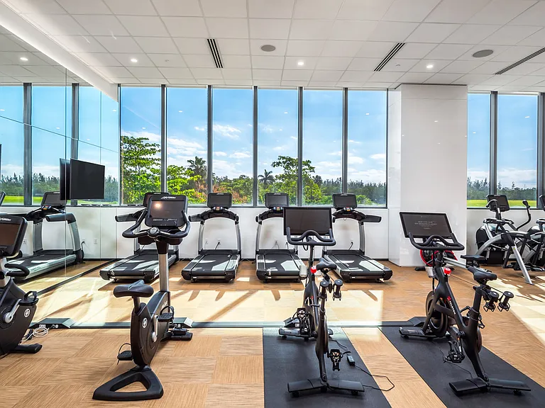 Floor-to-ceiling windows bring natural light and inspiring views into the fitness center.