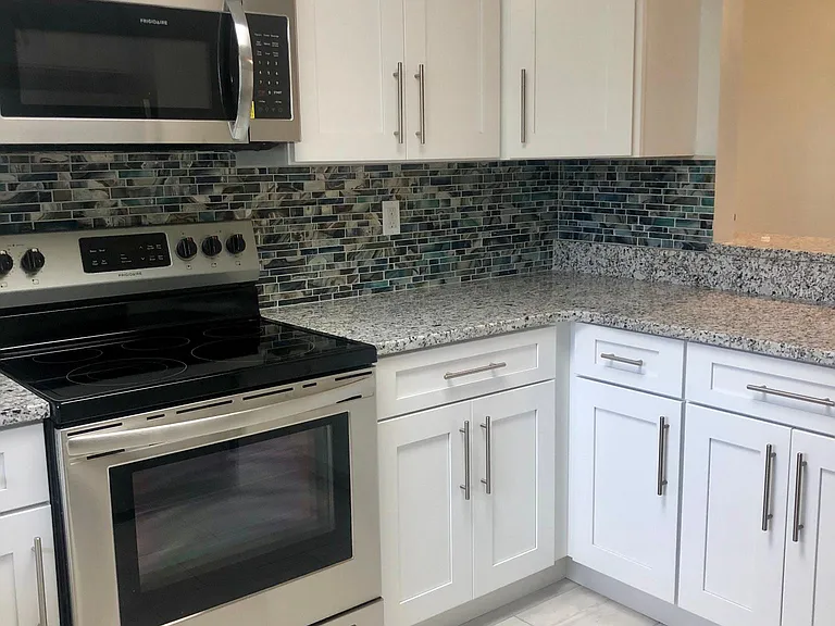All new never used kitchen with beautiful glass tile backsplash and granite countertops.