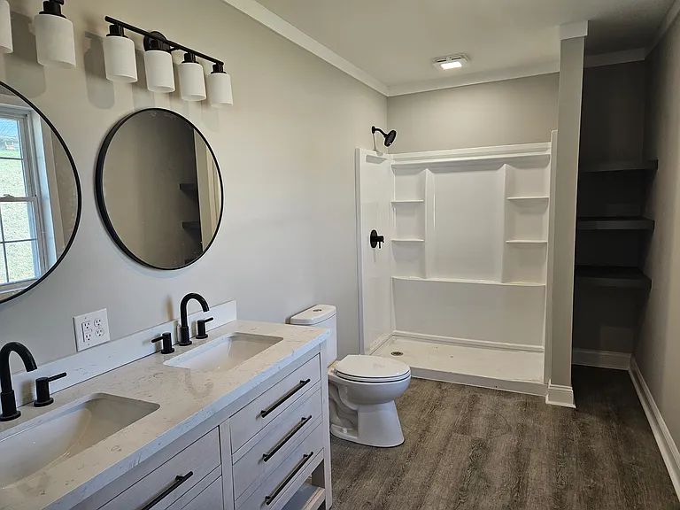 Primary 7x13 ft bathroom with walk-in shower and double sink