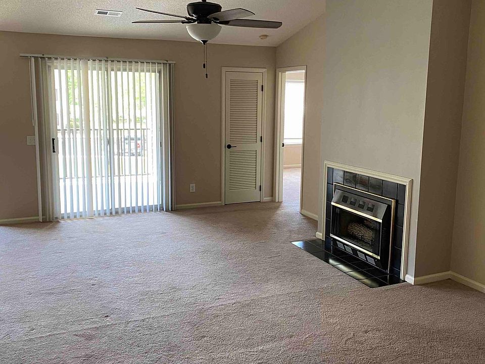 Living Room with Gas fireplace and balcony / patio entrance.